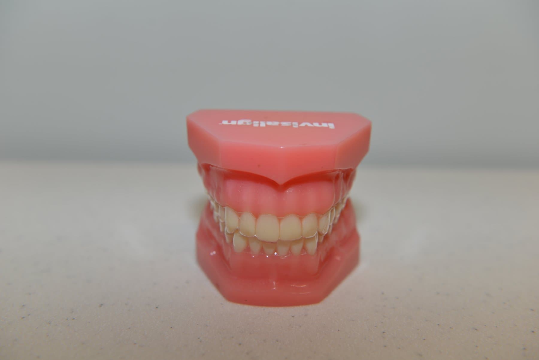 Photo of Invisalign aligners on a teeth model